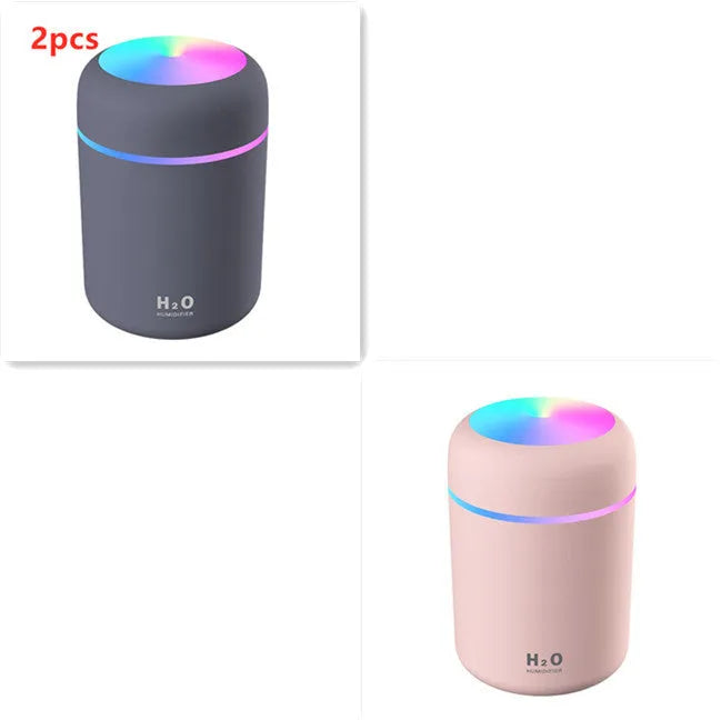 Pink USB portable humidifier with 300ml water tank on wooden desk surface