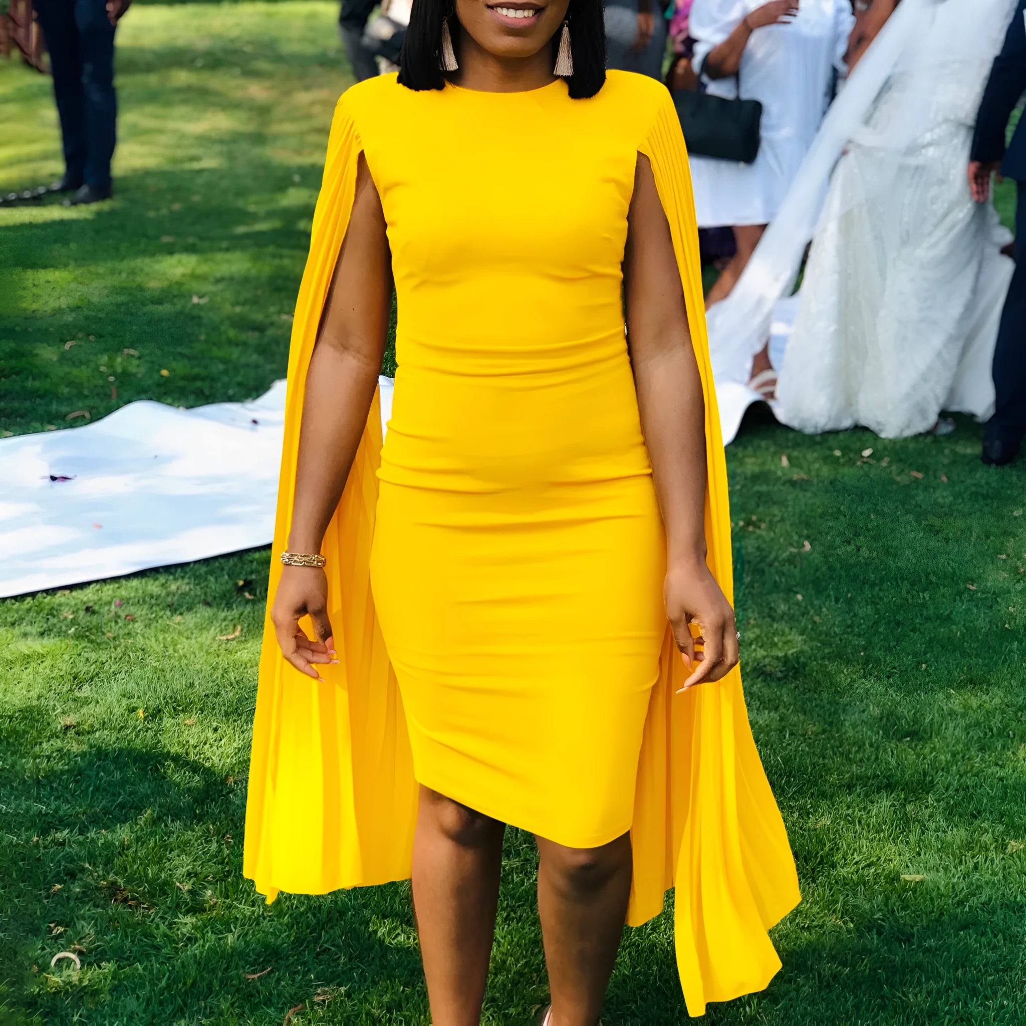 Yellow women's long sleeve evening gown with high waist and a pleated shawl draped over the shoulders.