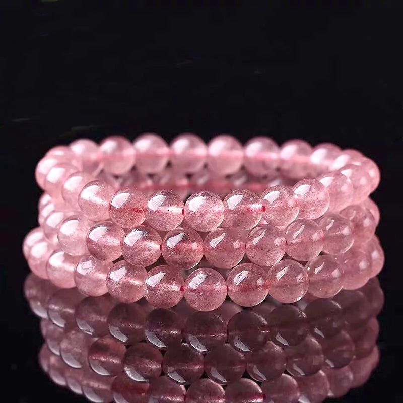 Women's strawberry quartz crystal bracelet with polished beads in three size options.