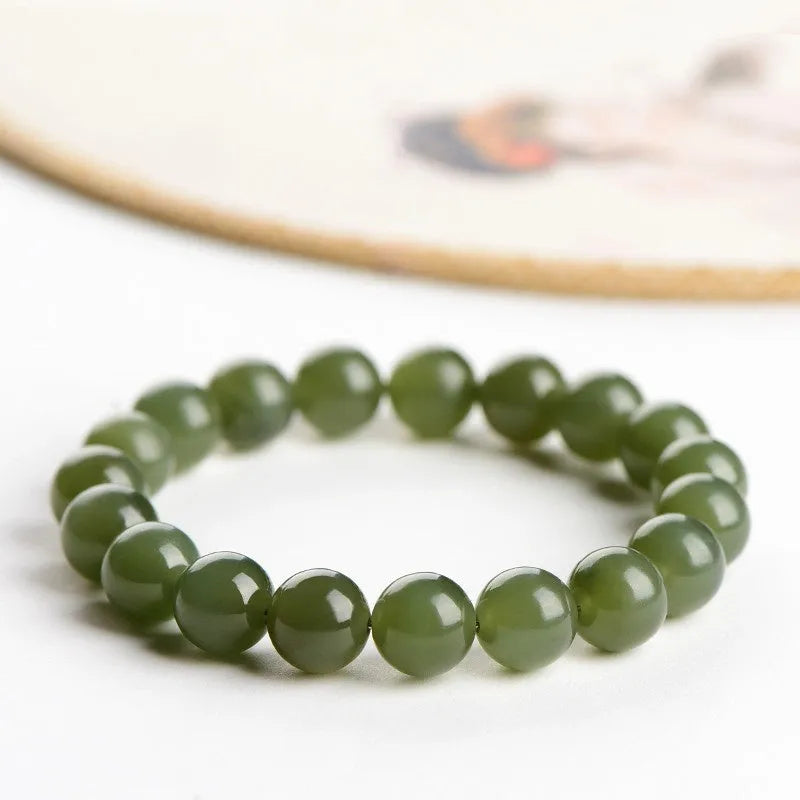 Hetian jade ball bracelet with polished spherical beads on a string, shown in deep and light clear water colour options.