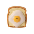 Yellow bread-shaped latex dog chew toy with cartoon pattern and squeaker for puppy training