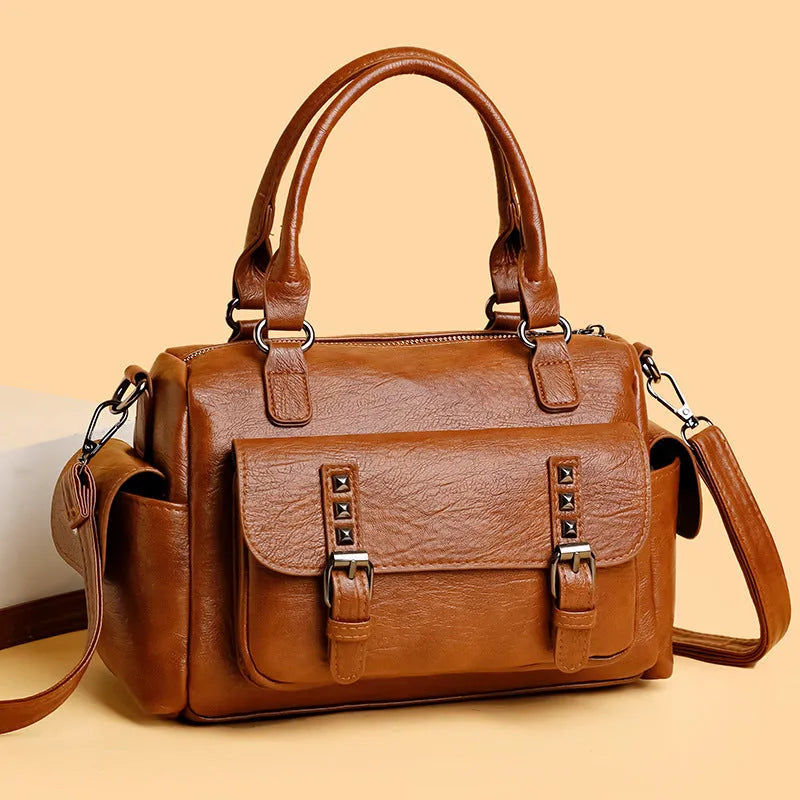 Vintage messenger bag in horizontal square shape showing contrast stitching details and shoulder strap