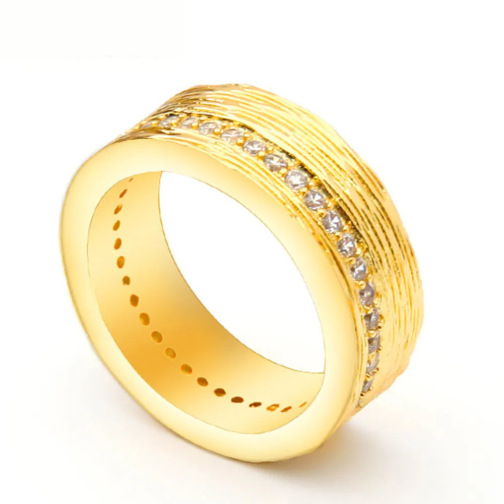 Women's geometric zircon ring in gold electroplated copper showing structured design lines