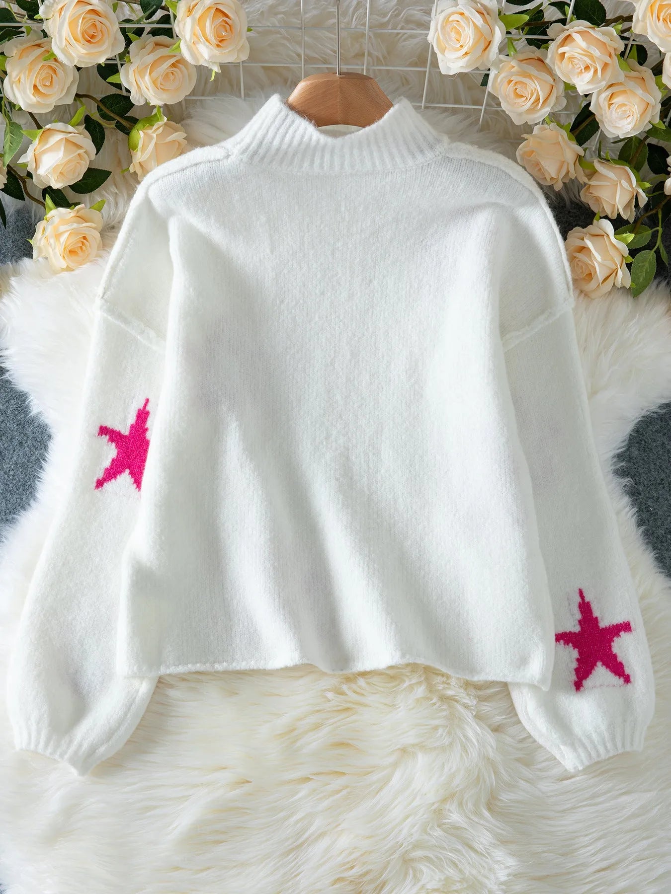 White women's loose fit turtleneck pullover with five-pointed star pattern detail