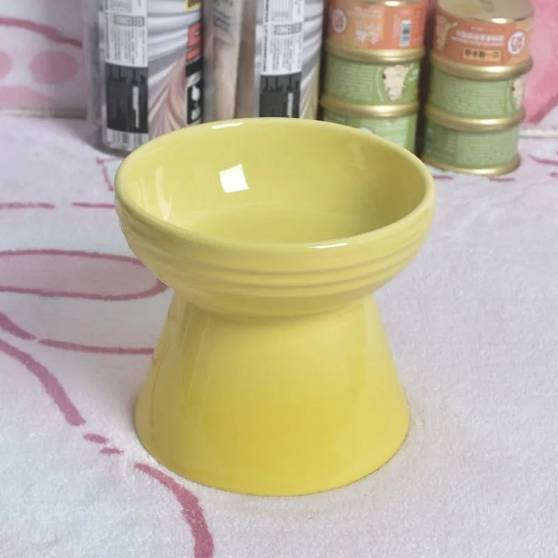 A white ceramic pet bowl with a high foot and raised neck protector to prevent tipping.