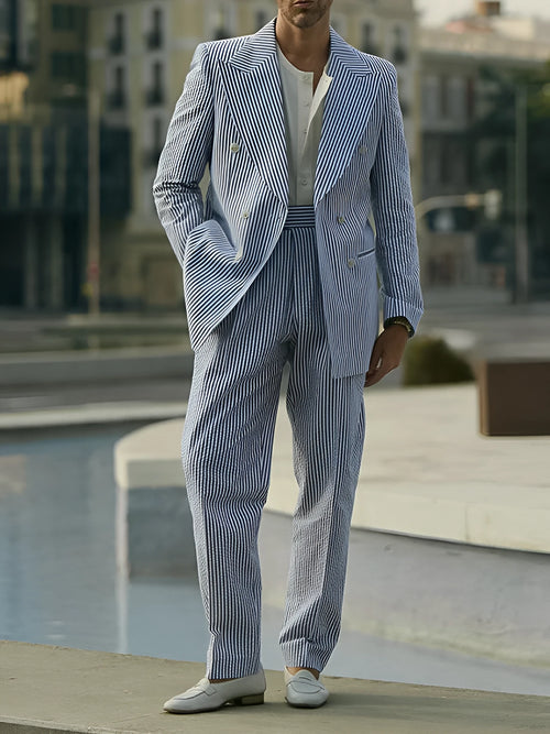 Blue and white striped polyester suit set with blazer and trousers on a hanger.
