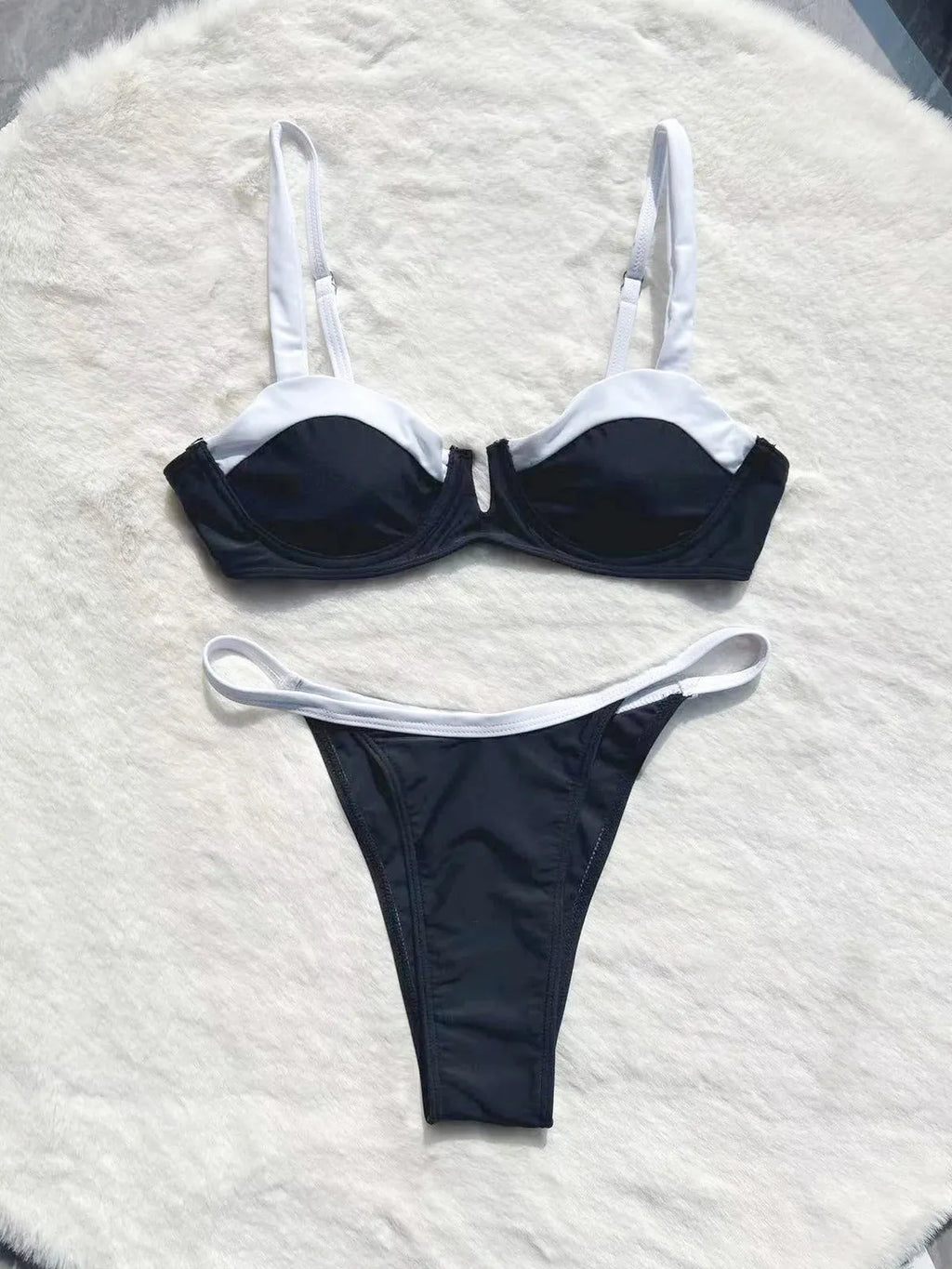 Black women's low-waist bikini swimsuit with brief bottoms and side stitching.