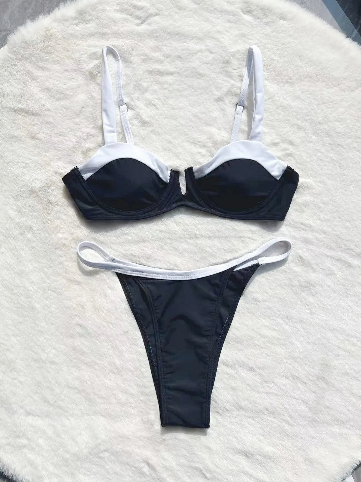 Black women's low-waist bikini swimsuit with brief bottoms and side stitching.