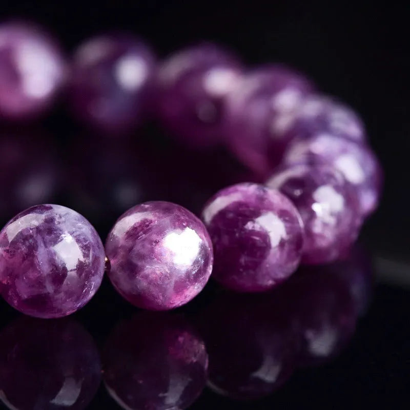 Grandmother Crystal purple bracelet with geometric beads in a single circle on a white background.