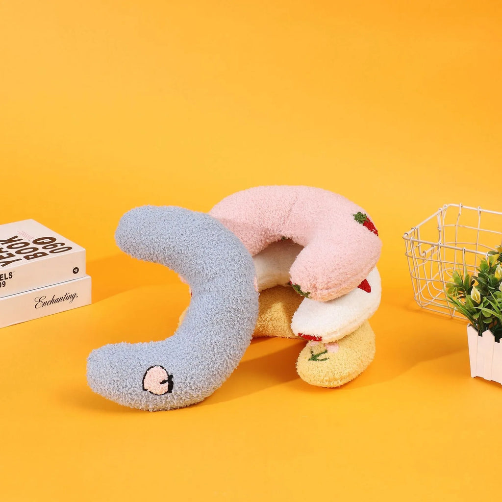 Half moon U-shaped cat pillow with cartoon dog and cat print in blue, pink, white, or yellow.