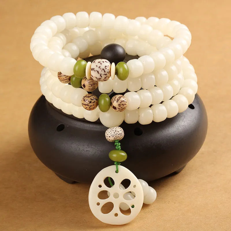 White jade Bodhi seed bracelet with 6x8mm beads showing multiple decorative style options