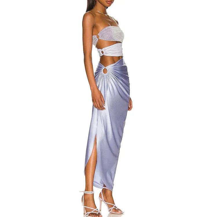 Purple one-piece swimsuit and matching wrap skirt set laid flat.