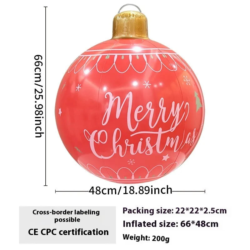 Large red inflatable Christmas ball with snowflake design and LED lights in outdoor garden setting
