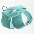 Soft pink microfiber puppy chest strap with a large white bowknot decoration laid flat.