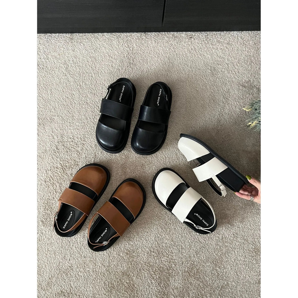 Retro closed toe sandals with raised bottom, ankle strap buckle, and round toe in apricot colour