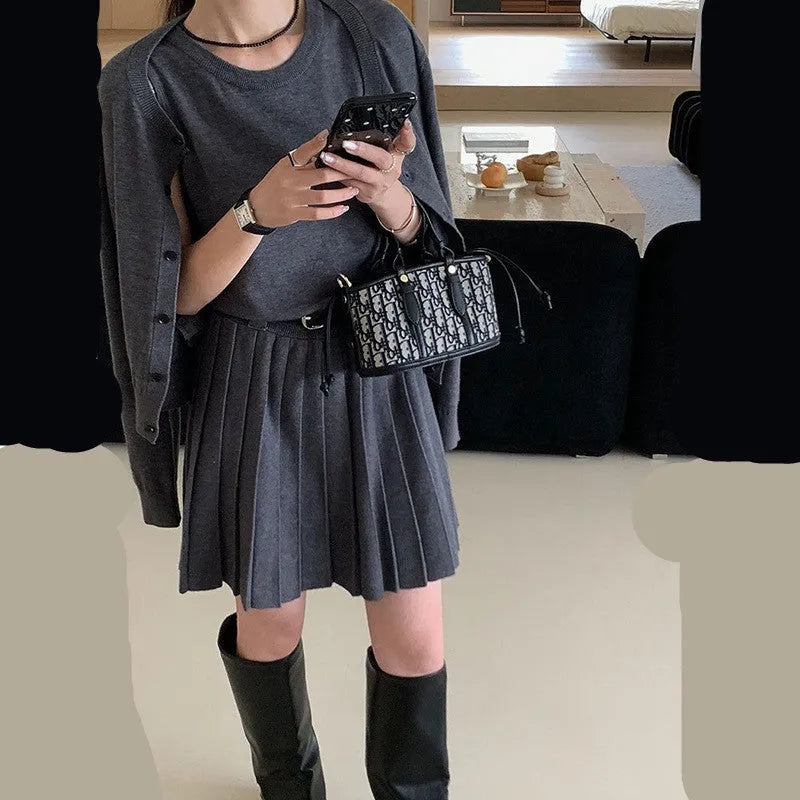Women's grey knitted two-piece set with vest skirt, long-sleeved cardigan, belt, and 3D pattern detail