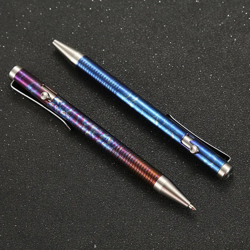 Titanium alloy gun bolt handle ball pen with a randomised phantom colour finish on a dark background.