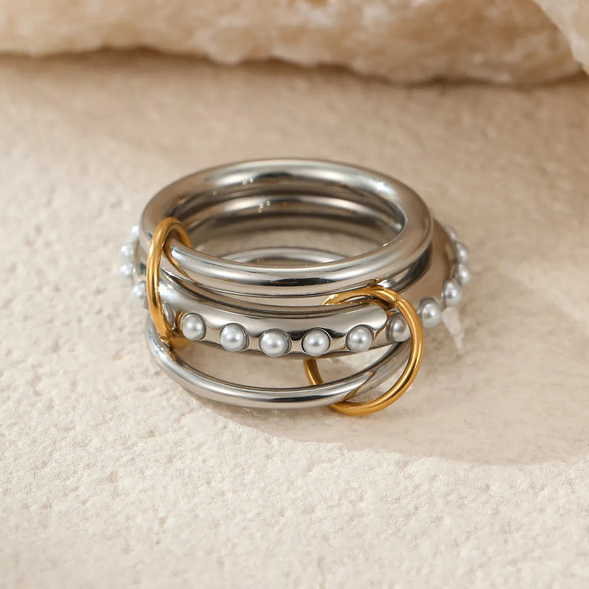 Stacked colour matching stainless steel ring set with 18K gold plating and exaggerated profile
