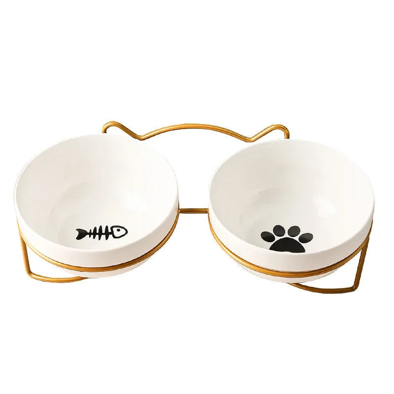 Ceramic cat bowl with iron frame stand showing cat paw print pattern and gold metal finish