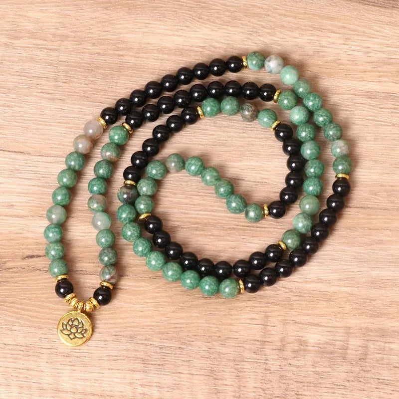 Green and black elastic beaded bracelet with alloy metal construction and natural style design