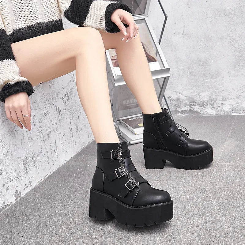 Black women's gothic punk ankle boots with a large bat-shaped buckle and a side zipper.