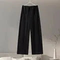 Women's apricot polar fleece suit set with long sleeve top and wide leg trousers on a hanger.