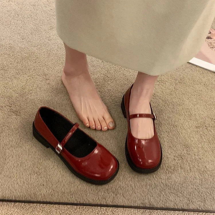 Women's solid colour French vintage flat shoes with a round toe, shown in red, black, and grey.
