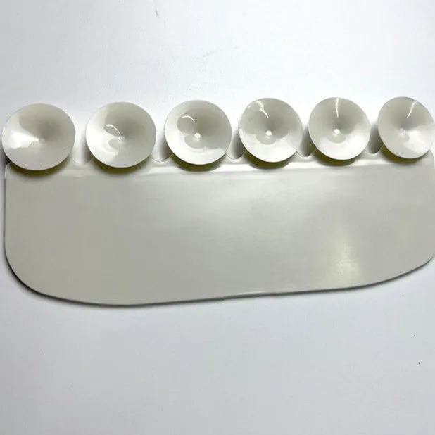 White PVC children's toilet training splash guard placed on a toilet seat.