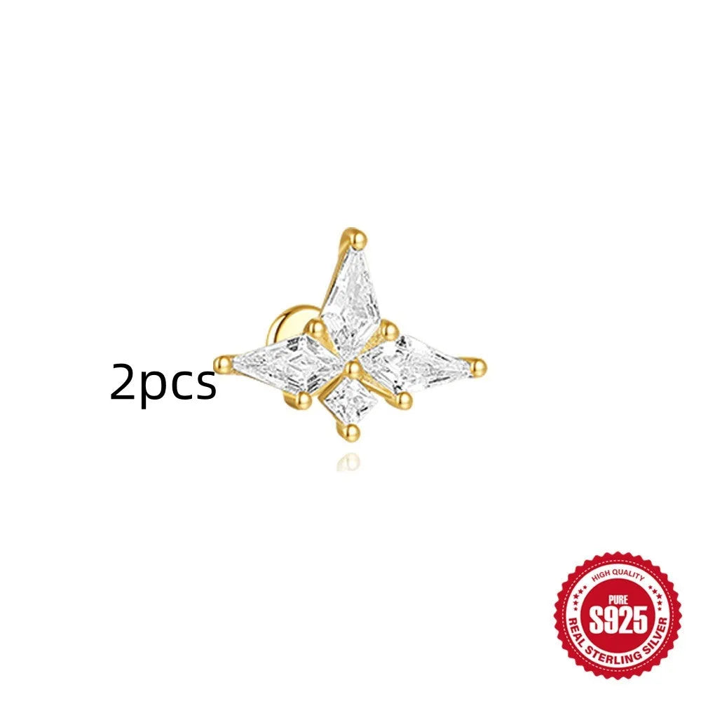 Geometric kite-shaped sterling silver earring with rhinestone head and gold chain tassel.