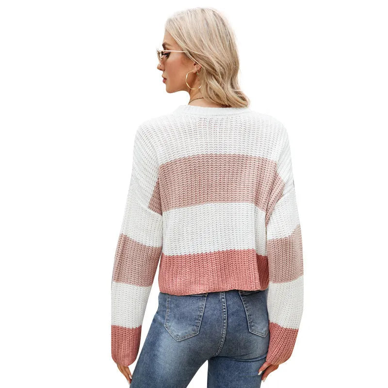 Women's short striped loose pullover sweater in acrylic knit on a hanger.