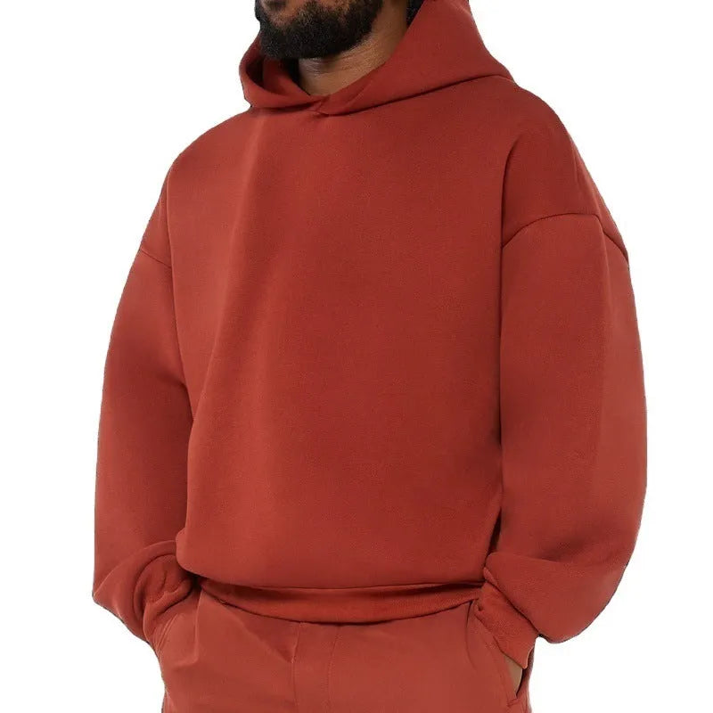 A man's grey fleece-lined cotton pullover hoodie on a hanger.