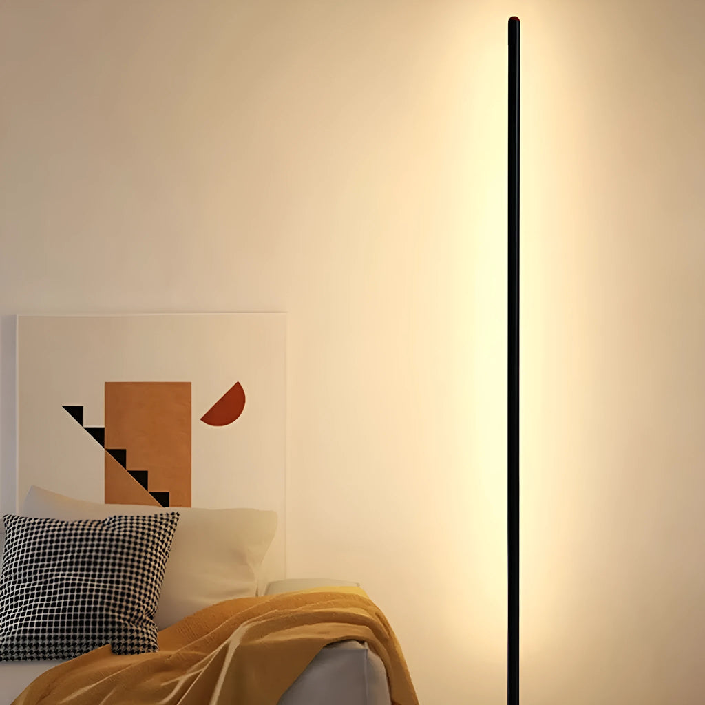 Simple modern vertical aluminium alloy floor lamp in silver, shown beside a sofa.