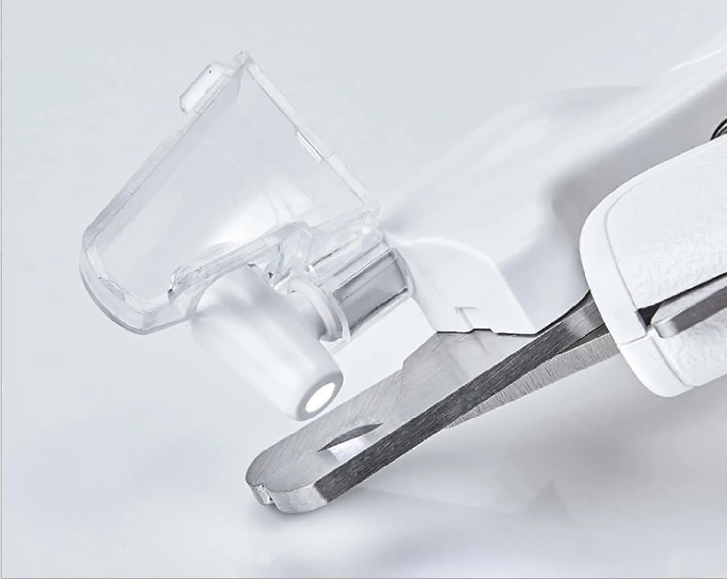 White pet nail clippers with LED light, transparent anti-splash baffle, and a nail file.