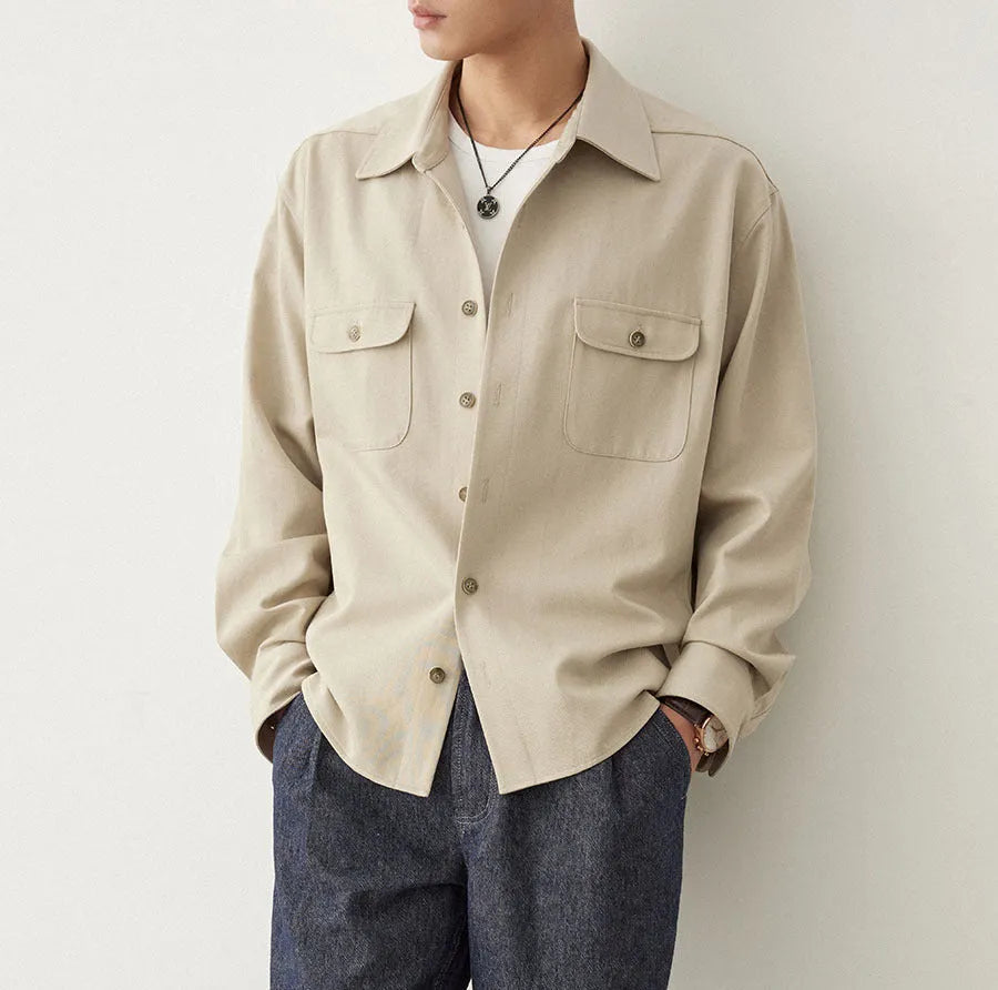 Men's light sand rice coloured cotton blend lapel shirt laid flat, showing long sleeves and simple collar design.