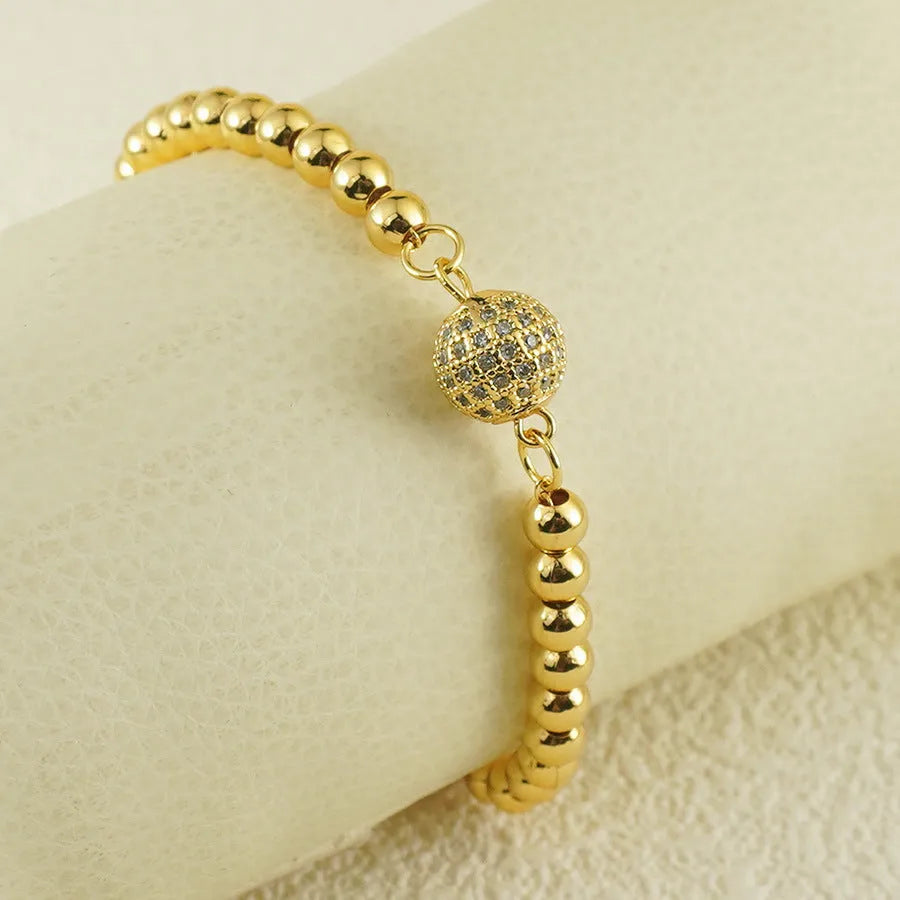 Copper bracelet with heart shape design, zircon accents and Arabic style patterning