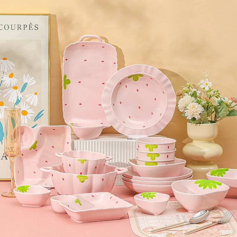 Cute strawberry design porcelain dinnerware set with flower bowls, straw hat plates, and a twist spoon.