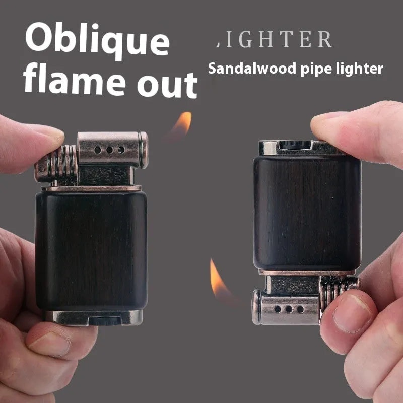 Ebony gas lighter with carved rosewood good luck design on a metal body.