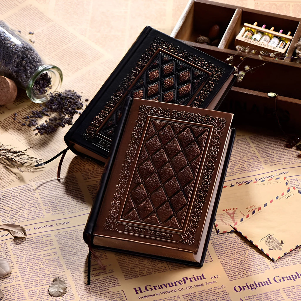 Embossed faux leather notebook in bronze colour, open to show thick white pages.