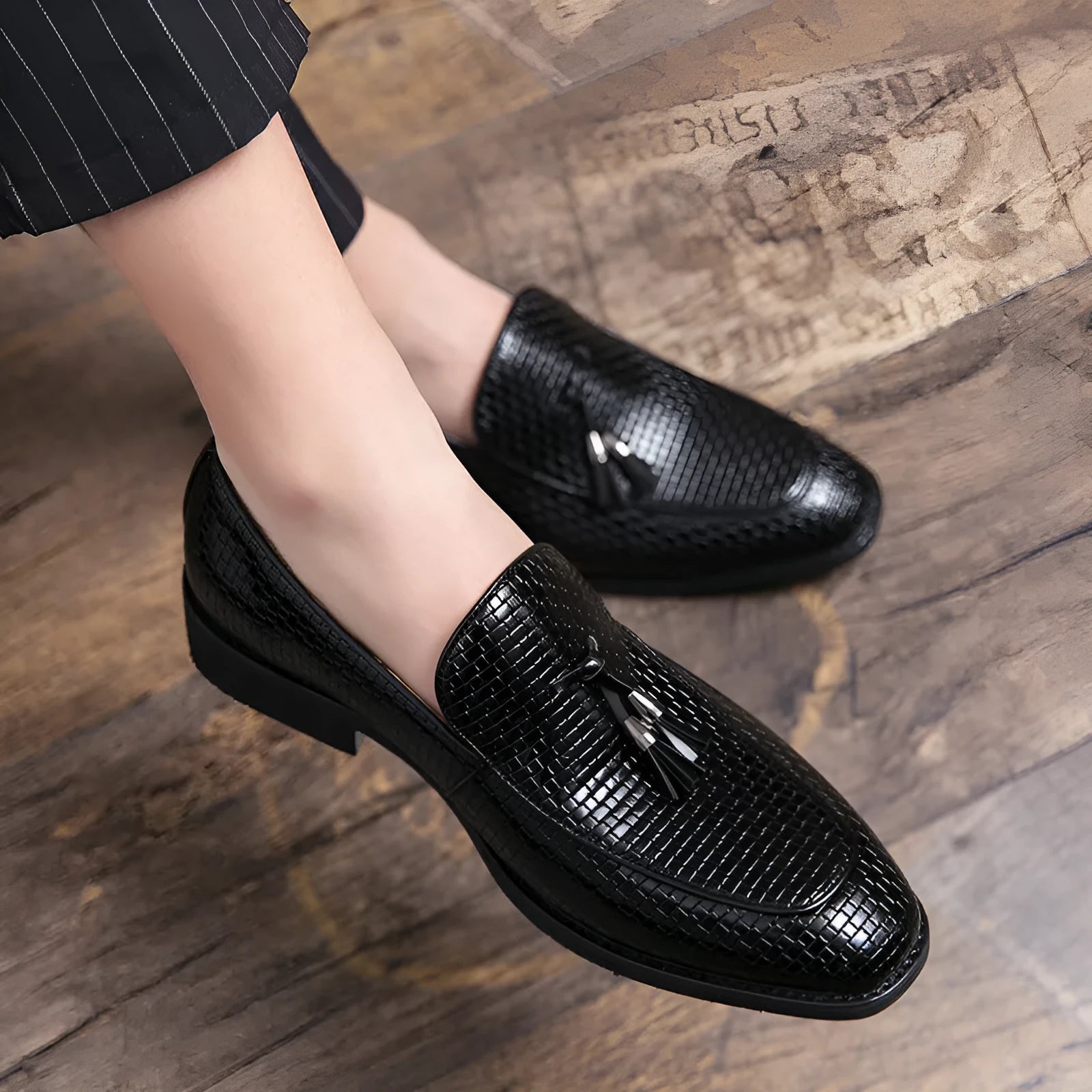 Men's black pointed toe slip-on business shoes with tassel detail on artificial PU leather upper