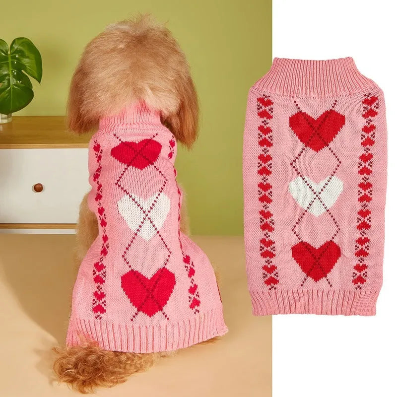 Red and pink dog sweater with love heart and bow design on a small dog.