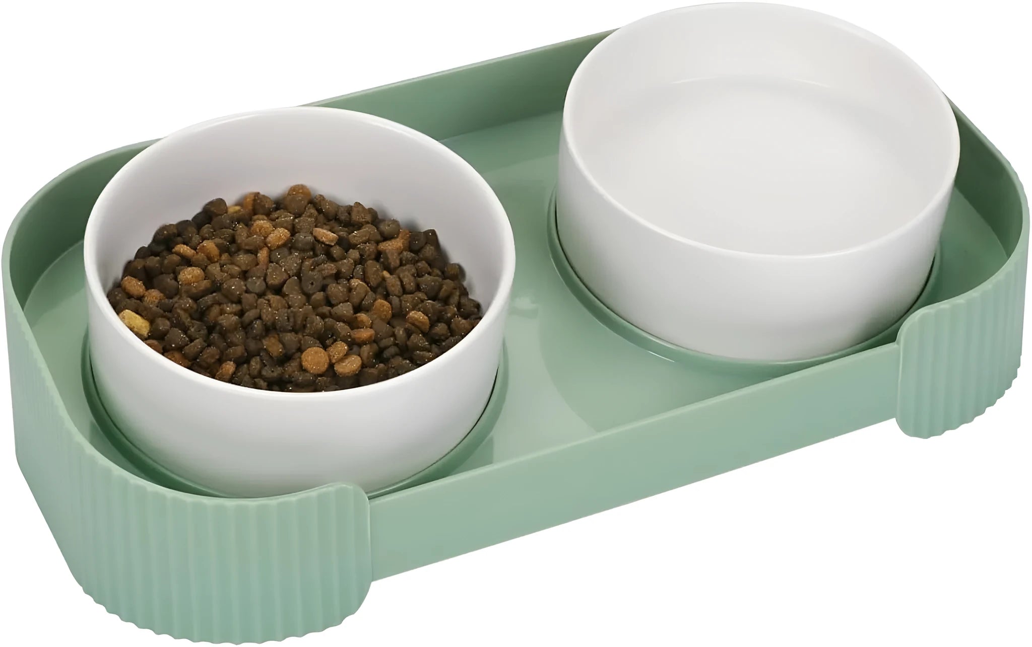Green ceramic raised cat food and water bowls set with tilted stand on a kitchen floor.