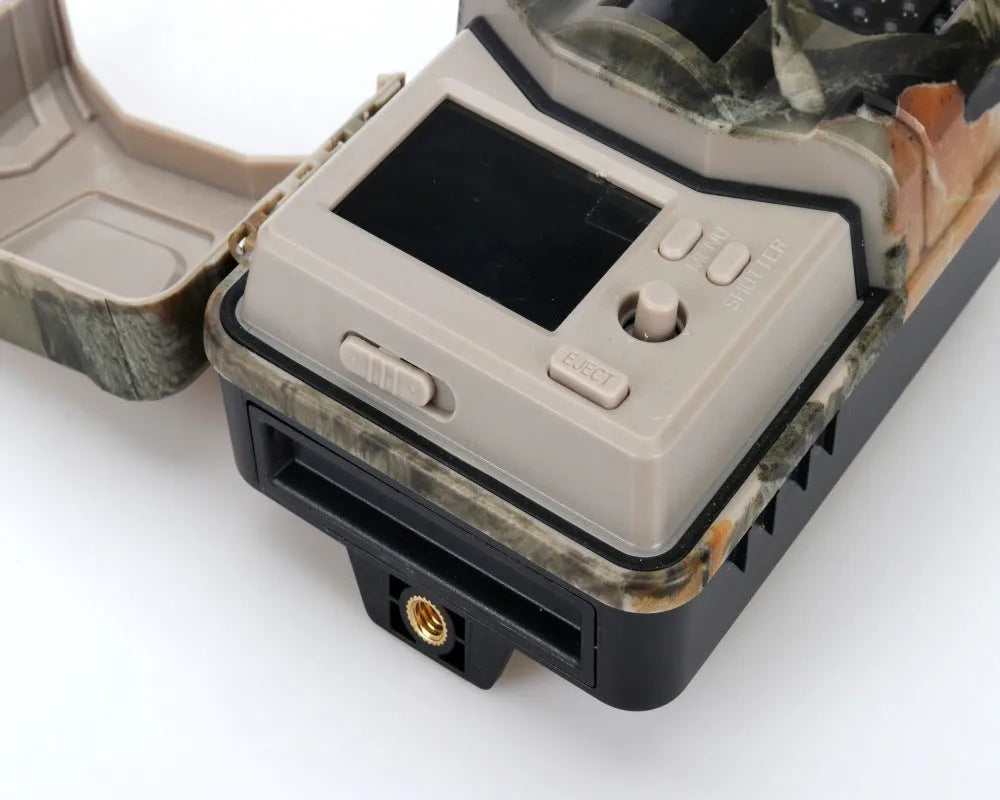 Compact camouflage outdoor hunting camera with infrared LEDs for night vision and Bluetooth connectivity.