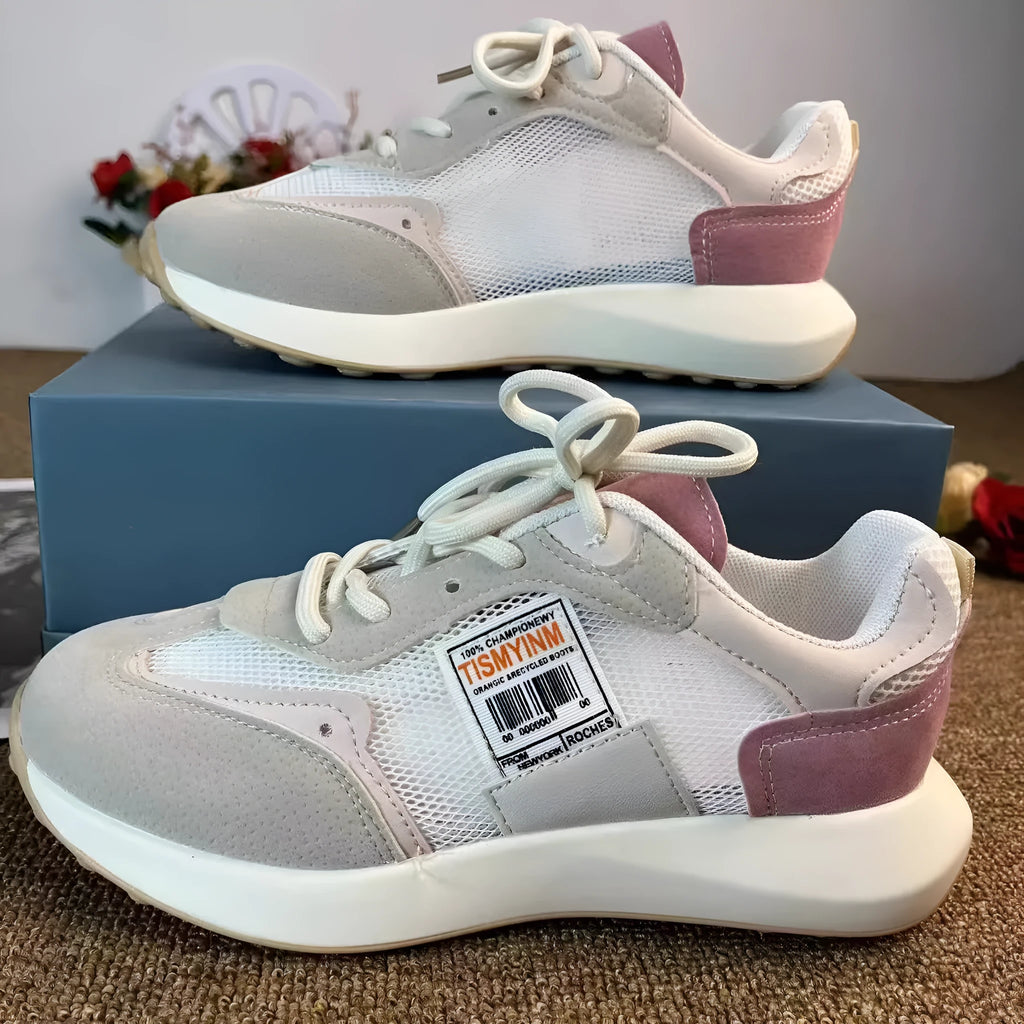 Grey and pink women's low-top retro sneakers with round toe and shallow mouth on a rubber sole.