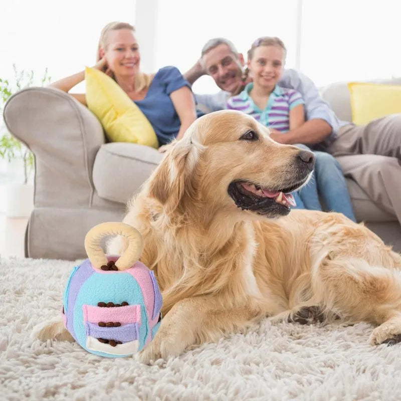 Green polyester squeaky plush ball dog toy with treat pockets on grass