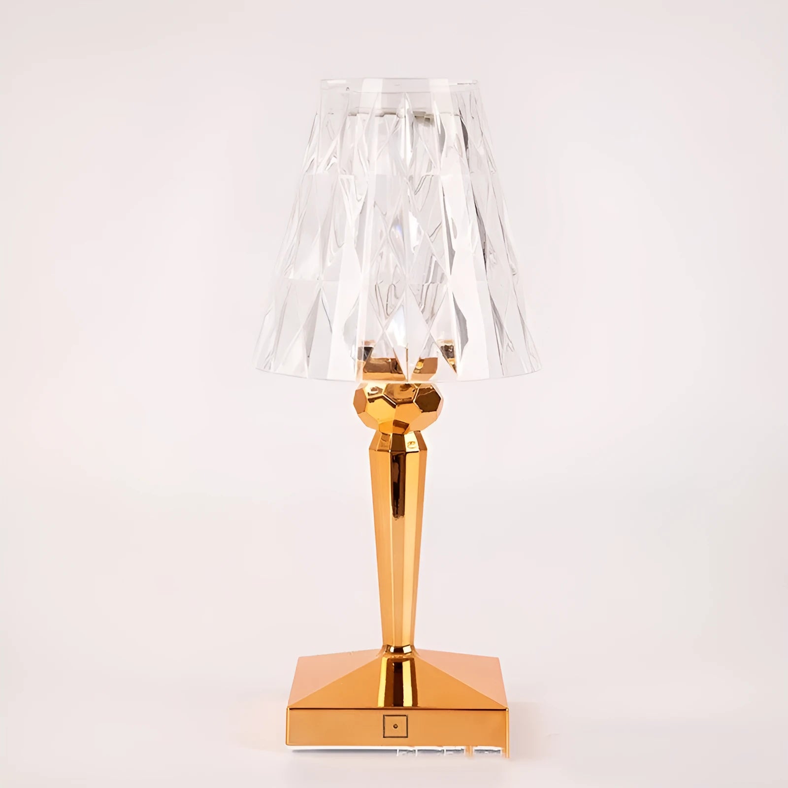 Rose gold portable touch night light with acrylic lamp holder on a surface.