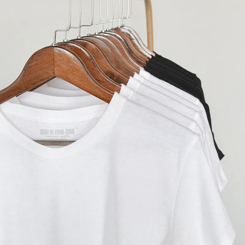 Men's solid colour cotton T-shirt on a hanger, showing the round neck and short sleeve design.