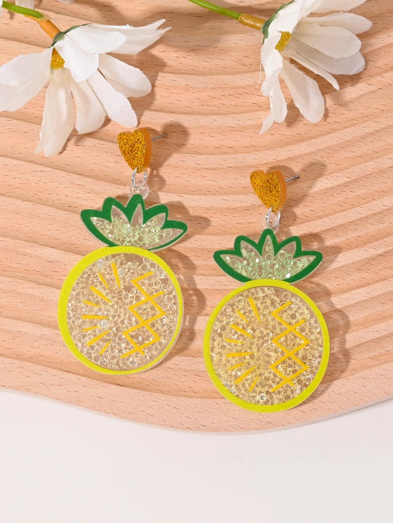 Colourful acrylic novelty earrings shaped like fruits and desserts including cherry, strawberry, and ice cream.