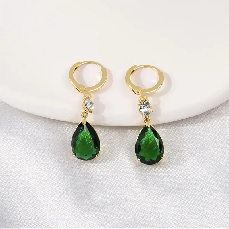 Green geometric teardrop alloy earrings showing structured design from multiple angles