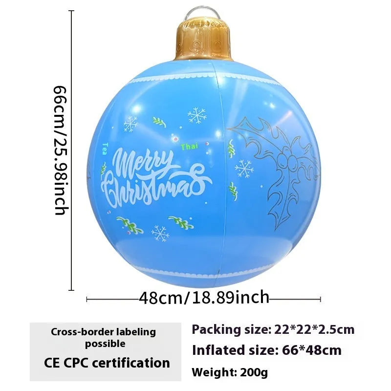 Large red inflatable Christmas ball with snowflake design and LED lights in outdoor garden setting