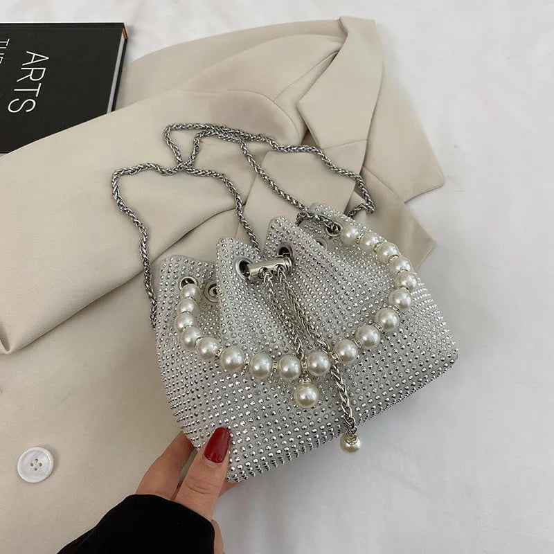 Diamond pattern crossbody bag with chain strap in bucket shape showing internal organisation compartments
